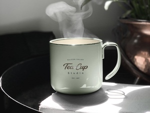 Front View of Ceramic Tea Cup Mockup on Table