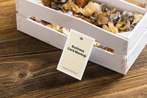 Perspective View of a Business Card Mockup Leaning on a Wooden Box