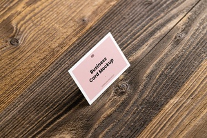 Perspective View of Business Card Mockup in Wood Background