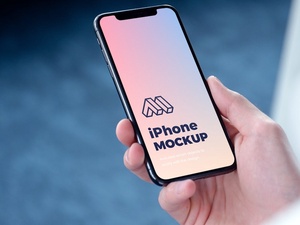 Perspective View of Hand Holding iPhone Mockup